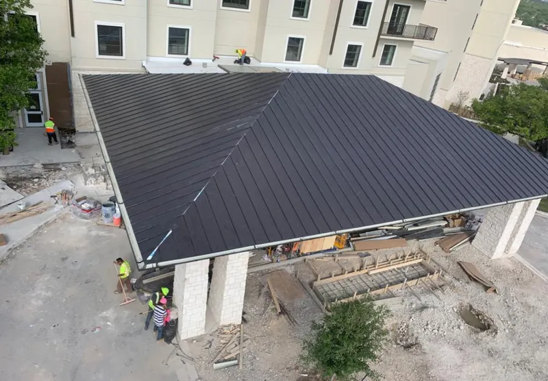 Metal roofing installation team working on a commercial building in Union